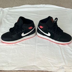 Black and hot pink Nike high tops.